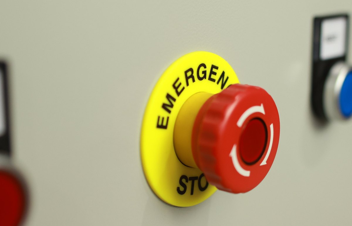 Emergency stop button on a machine control panel